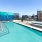 a pool with a large apartment building in the background